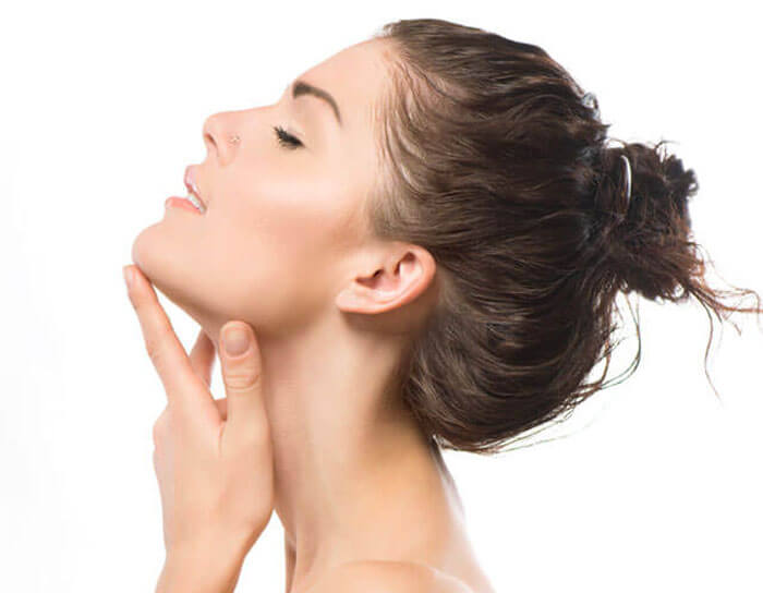 Portrait of a woman's profile holding her perfectly shaped chin